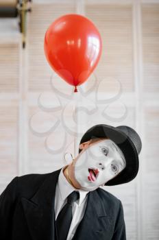 Mime artist, strangulation with air balloon, comedy parody. Pantomime theater, comedian, positive emotion, humour performance, funny face mimic and grimace