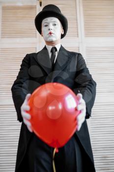Mime artist, scene with air balloon, comedy parody. Pantomime theater, comedian, positive emotion, humour performance, funny face mimic and grimace