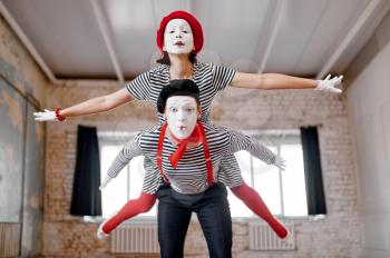 Two mime artists, airplane parody scene, comedy. Pantomime theater, comedian, positive emotion, humour performance, funny face mimic and grimace