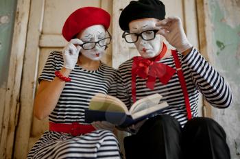 Two clowns in glasses, mime artists, parody comedy. Pantomime theater, comedian, positive emotion, humour performance, funny face mimic and grimace