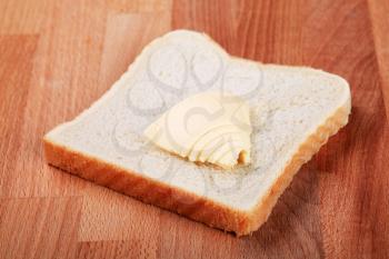 Slice of white bread and bit of butter