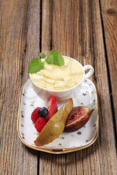 Bowl of creamy pudding and fresh fruit