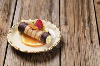 Cream filled wafer roll garnished with fresh fruit 