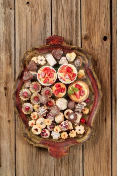 Various kinds of cookies and tarts on a tray