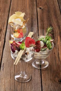 Various cheese appetizers in glass dishes - still life