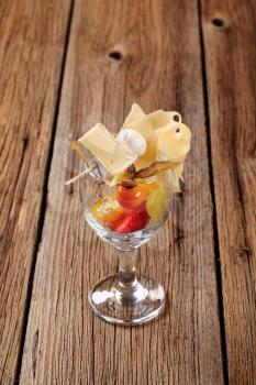 Cheese on cocktail stick and fresh fruit