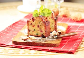Two pieces of fruit cake on cutting board