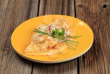 Egg omelet topped with fresh chives and onion