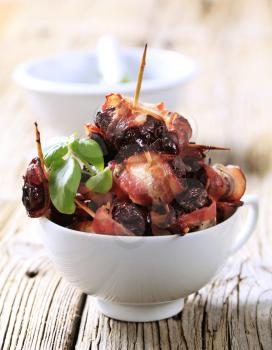 Prunes wrapped  in rashers of bacon - detail