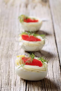 Boiled egg whites filled with red caviar