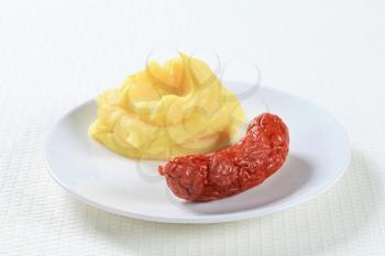 Dish of mashed potato and sausage 