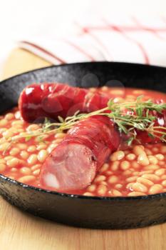 Baked beans and sausages on a fry pan