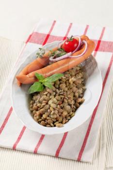 Simple dish of cooked lentils and frankfurters