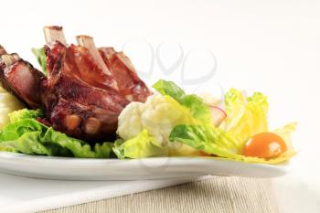 Smoked pork ribs and vegetable garnish