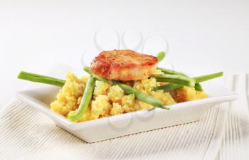Dish of marinated pork with couscous and green beans