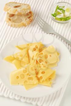 Thin slices of Swiss cheese, bread and spring onion 