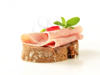 Thin-sliced ham on brown bread