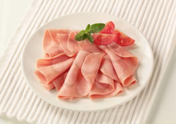 Thin slices of ham on a plate