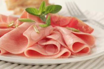 Thin slices of ham on a plate
