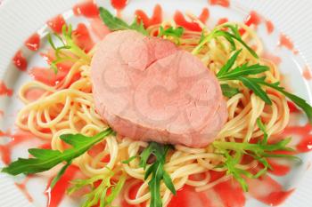 Pork fillet and spaghetti with raspberry balsamic reduction and rocket
