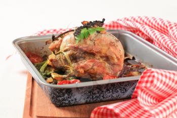 Roast pork with caraway and vegetables in a baking pan