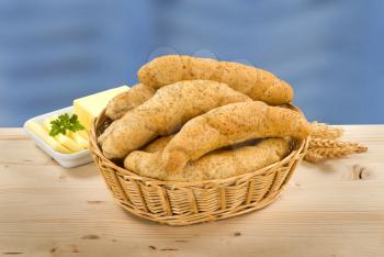 Wholegrain rolls in a basket and fresh butter