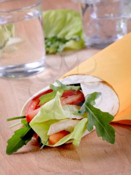 Wrap sandwich with chicken meat and vegetables