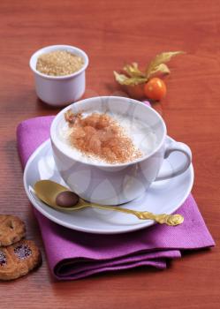 Cup of coffee with steamed milk and cinnamon