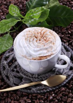 Cup of coffee with cream and nutmeg