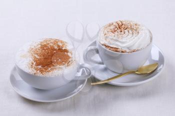 Cups of cappuccino and Vienna coffee