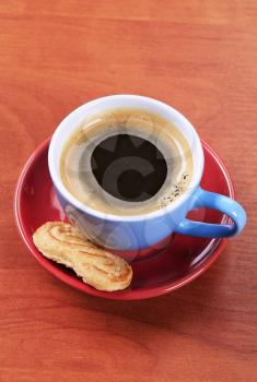 Cup of black coffee and biscuit