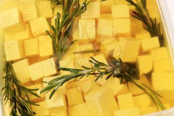 Feta cheese marinated in olive oil with pepper and rosemary