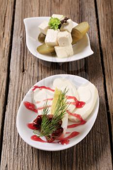 Slices of mozzarella and cubes of marinated feta cheese 