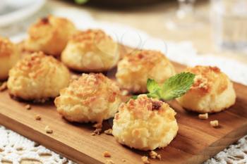 Freshly baked coconut macaroons on a cutting board