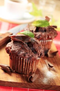 Delicious double chocolate muffins on cutting board 