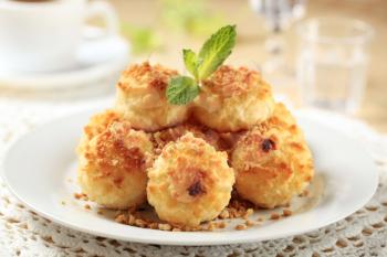 Coconut macaroons sprinkled with chopped nuts - closeup