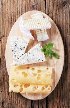 Variety of cheeses on a cutting board
