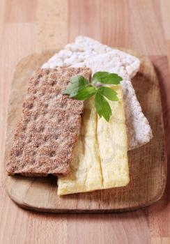 Various kinds of crispbread on a cutting board