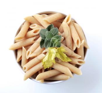 Bowl of whole wheat pasta tubes - overhead