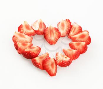 Wedges of fresh strawberries arranged in a heart shape