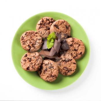 Chocolate chip cookies on a green plate - overhead