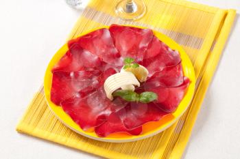 Thin slices of dry cured meat and butter