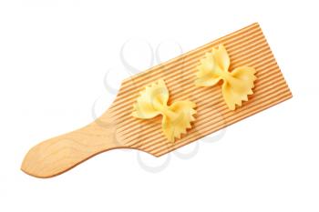 Bow tie pasta on a wooden cutting board