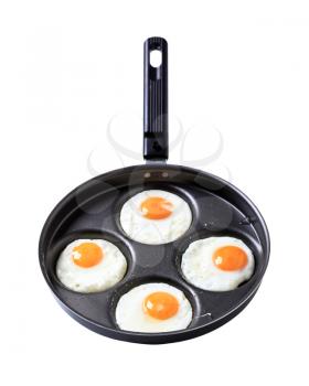 Four fried eggs on frying pan