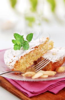 Slices of almond cake sprinkled with powdered sugar