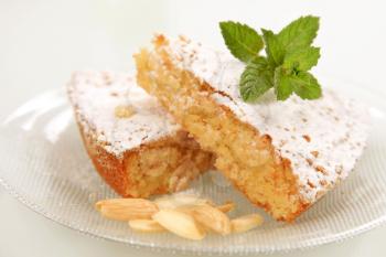Slices of almond cake sprinkled with powdered sugar