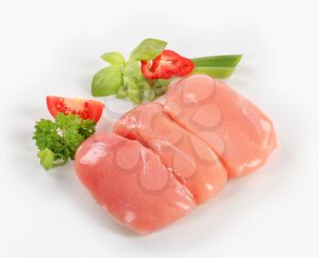 Raw chicken breast fillets and fresh vegetables