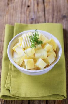 Bowl of diced potatoes with butter