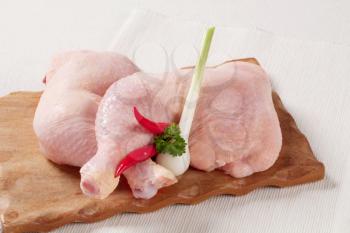 Raw chicken legs on a cutting board