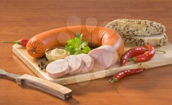 Soft salami, mustard and brown bread roll
